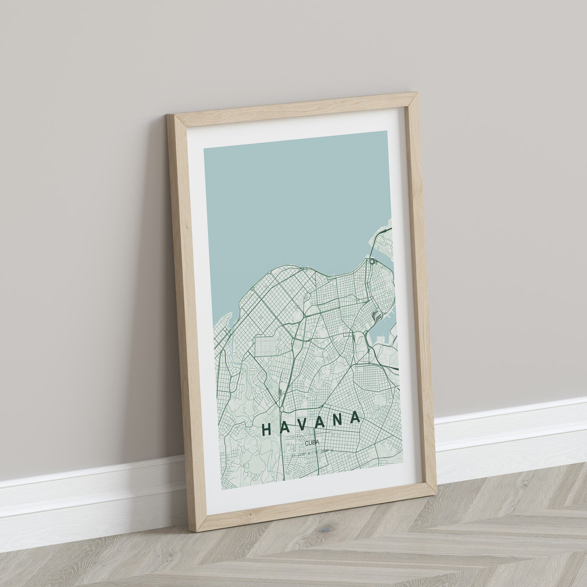 Havana, Cuba map print in the Forest theme in a light wooden frame leaning against a pale wall