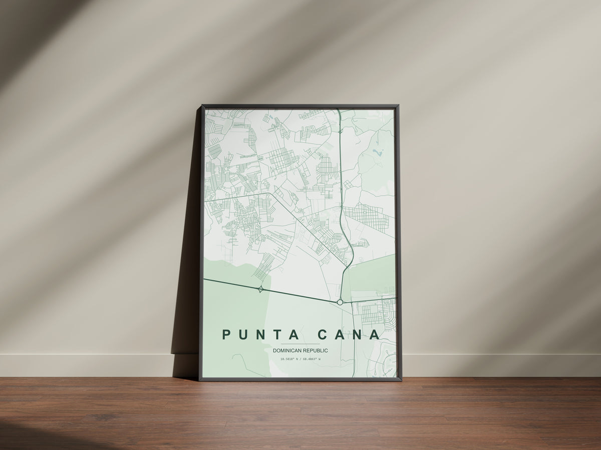 Punta Cana, Dominican Republic map print in the Forest theme in a black frame on a wooden surface against a pale wall