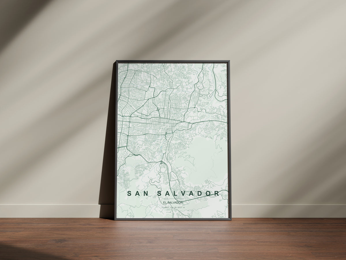 San Salvador, El Salvador map print in the Forest theme in a black frame on a wooden surface against a pale wall