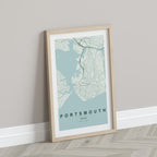 Portsmouth, England, United Kingdom map print in the Forest theme in a light wooden frame leaning against a pale wall