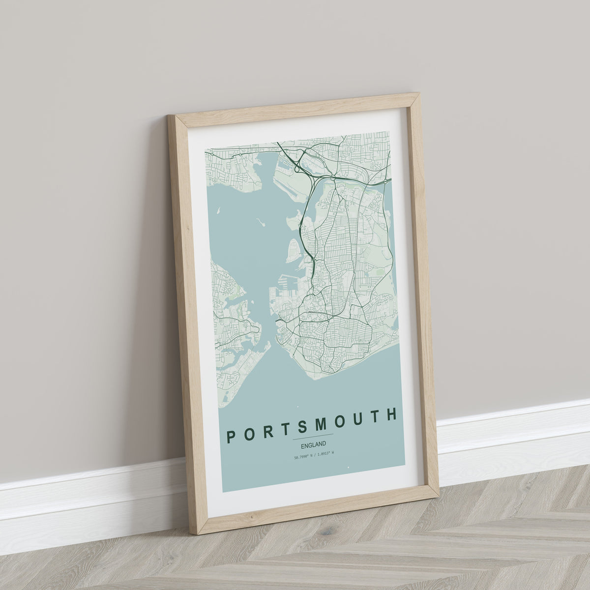 Portsmouth, England, United Kingdom map print in the Forest theme in a light wooden frame leaning against a pale wall
