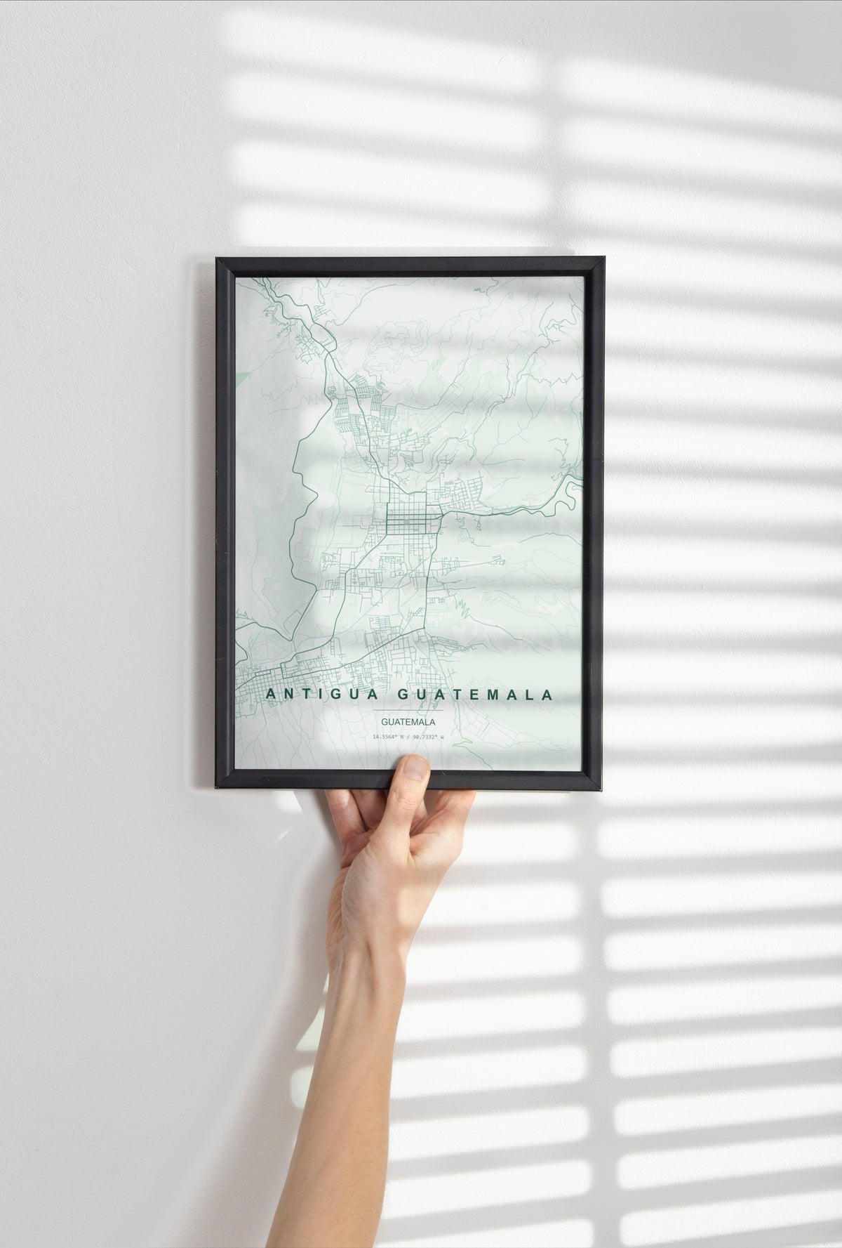 Antigua Guatemala, Guatemala map print in the Forest theme in a black frame held against a pale wall
