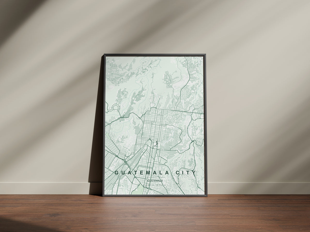 Guatemala City, Guatemala map print in the Forest theme in a black frame on a wooden surface against a pale wall
