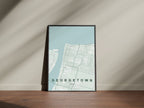 Georgetown, Guyana map print in the Forest theme in a black frame on a wooden surface against a pale wall