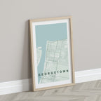 Georgetown, Guyana map print in the Forest theme in a light wooden frame leaning against a pale wall