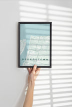 Georgetown, Guyana map print in the Forest theme in a black frame held against a pale wall