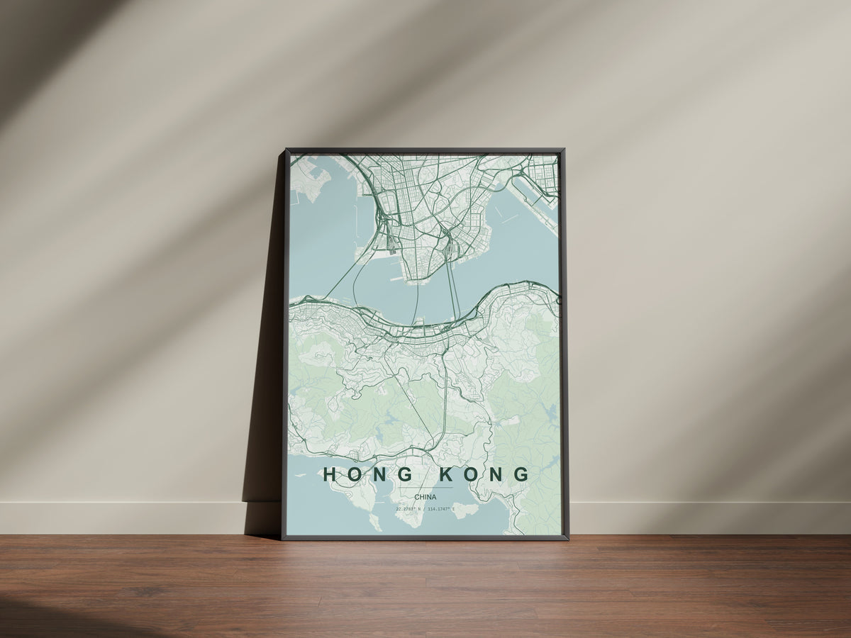 Hong Kong, China map print in the Forest theme in a black frame on a wooden surface against a pale wall