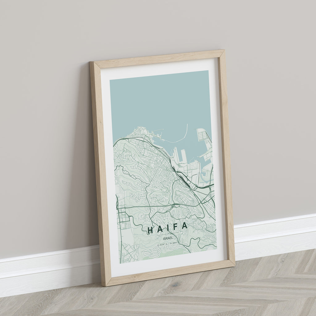 Haifa, Israel map print in the Forest theme in a light wooden frame leaning against a pale wall