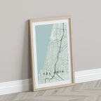 Tel Aviv, Israel map print in the Forest theme in a light wooden frame leaning against a pale wall