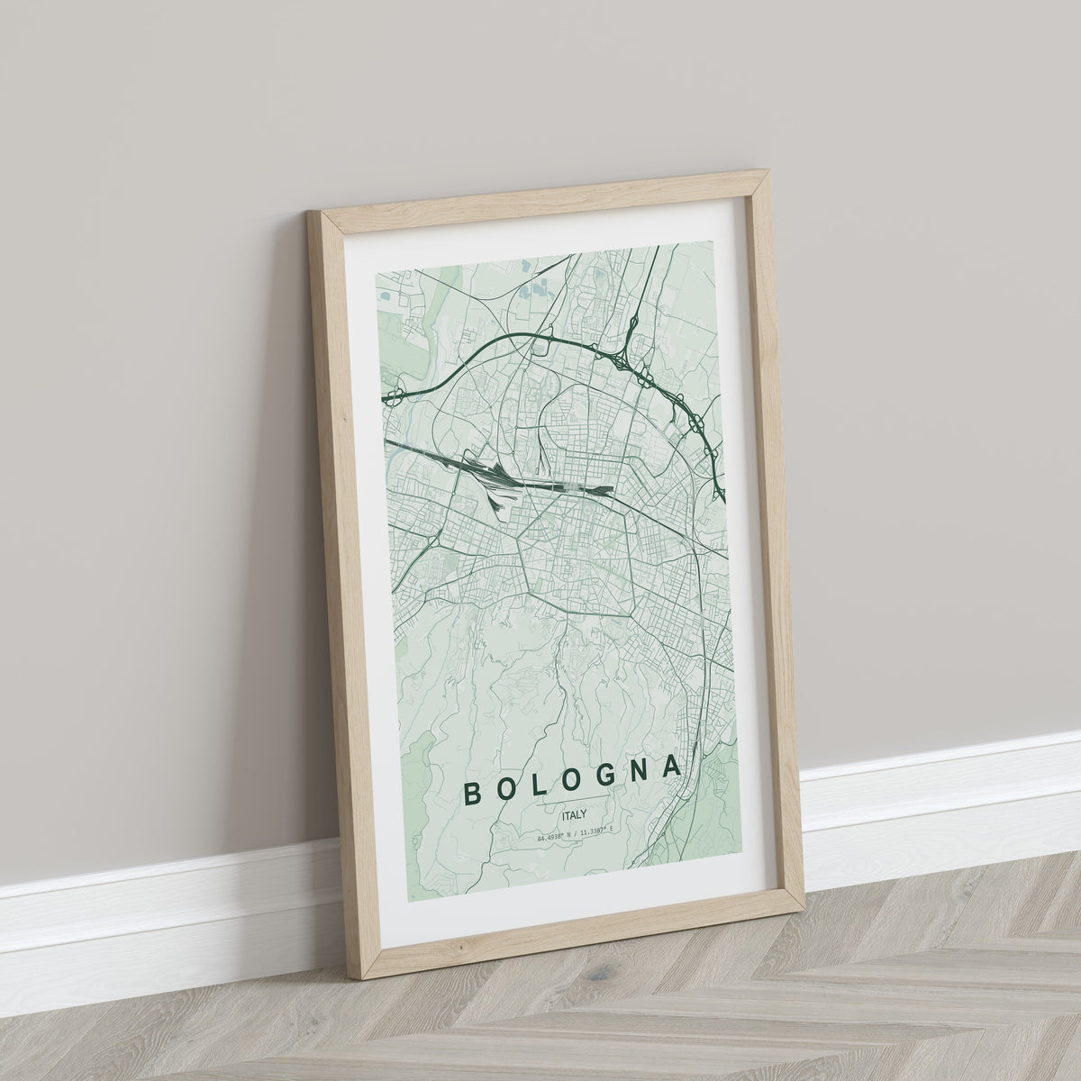 Bologna map print in the Forest theme in a light wooden frame leaning against a pale wall