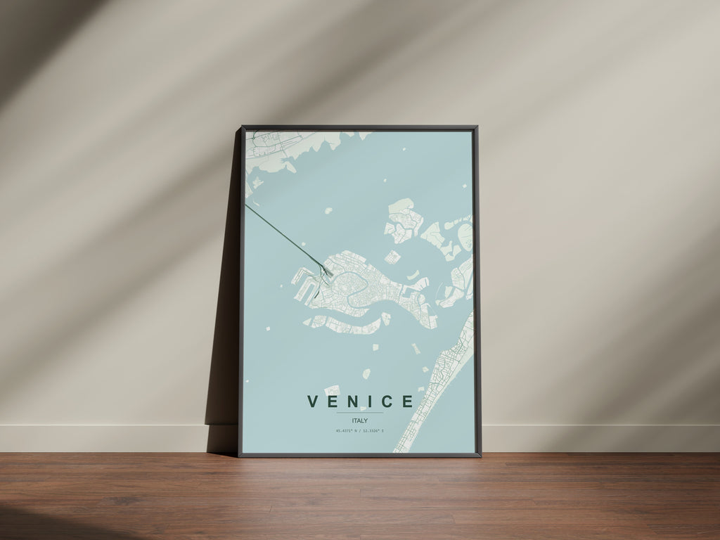 Venice map print in the Forest theme in a black frame on a wooden surface against a pale wall