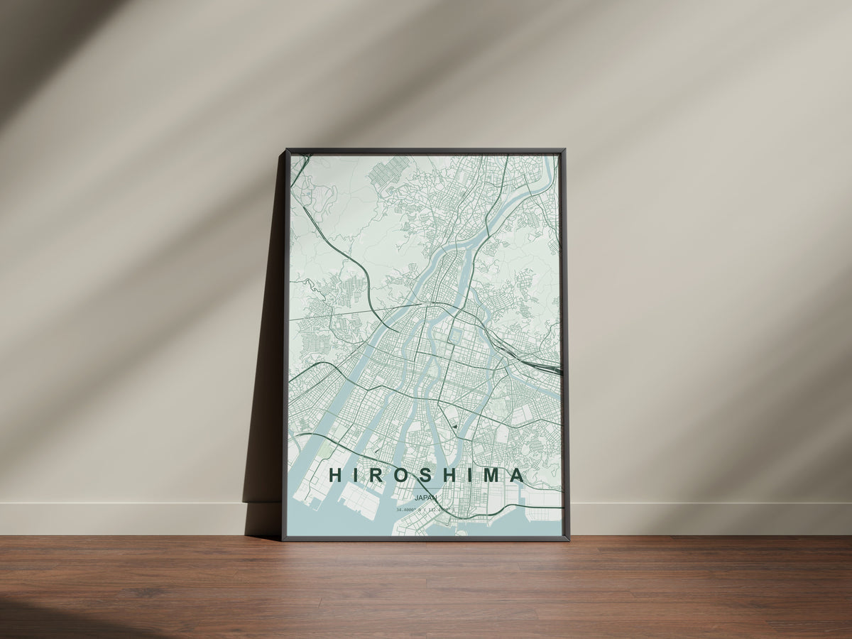 Hiroshima, Japan map print in the Forest theme in a black frame on a wooden surface against a pale wall