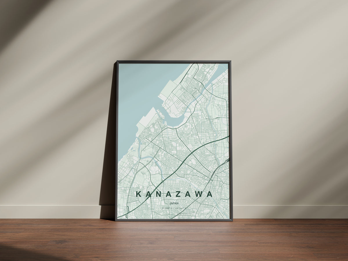 Kanazawa, Japan map print in the Forest theme in a black frame on a wooden surface against a pale wall