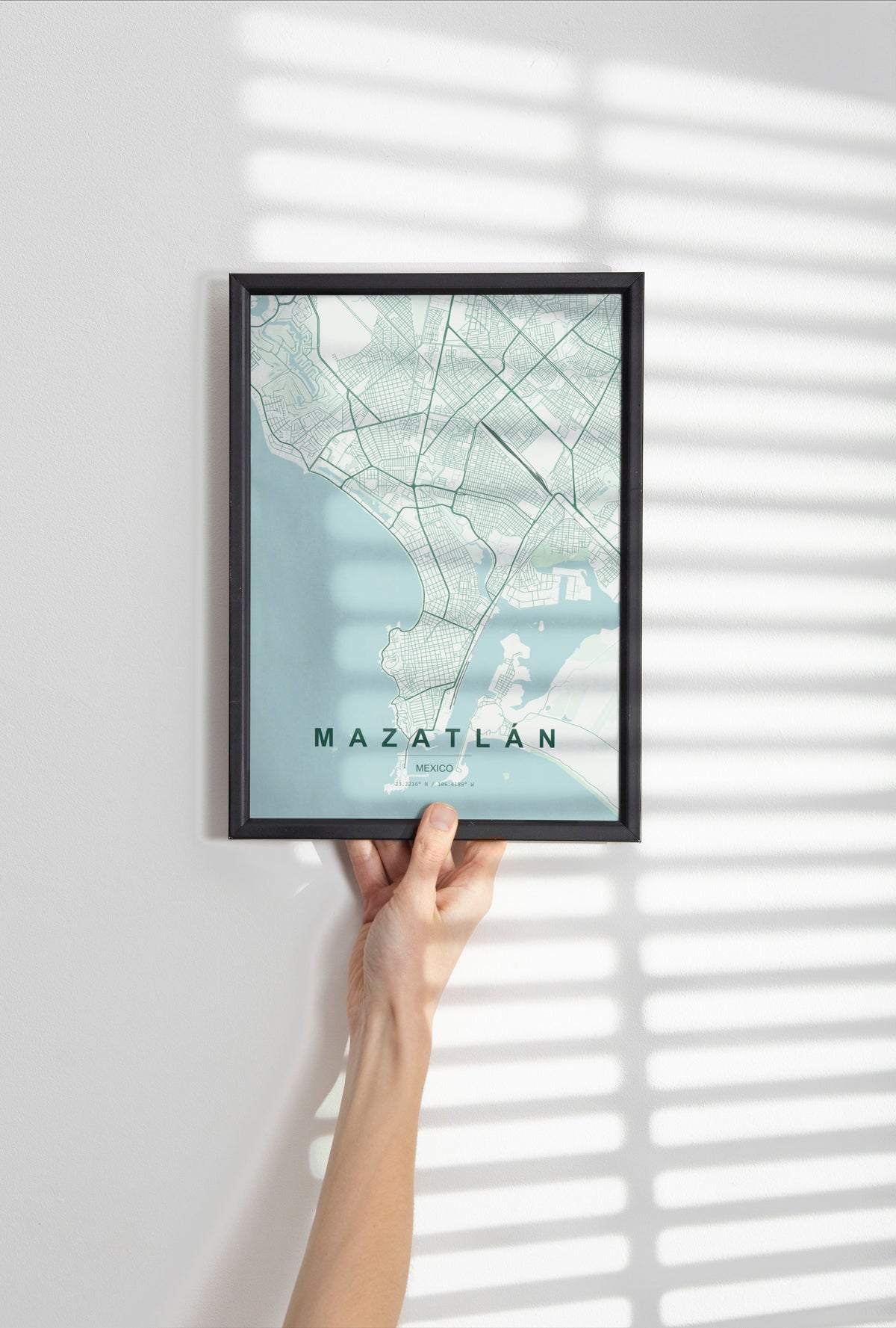 Mazatlán, Mexico map print in the Forest theme in a black frame held against a pale wall