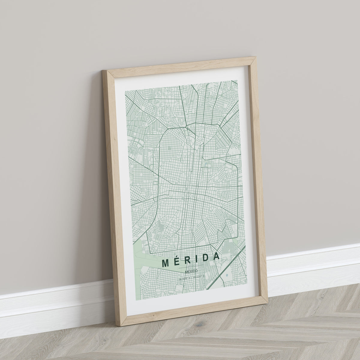 Mérida, Mexico map print in the Forest theme in a light wooden frame leaning against a pale wall