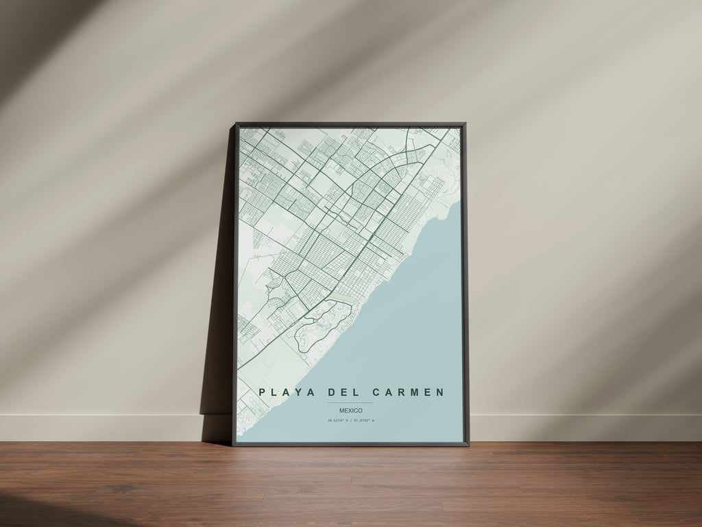 Playa del Carmen, Mexico map print in the Forest theme in a black frame on a wooden surface against a pale wall