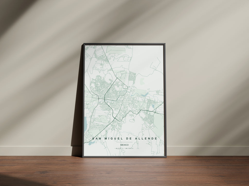 San Miguel de Allende, Mexico map print in the Forest theme in a black frame on a wooden surface against a pale wall