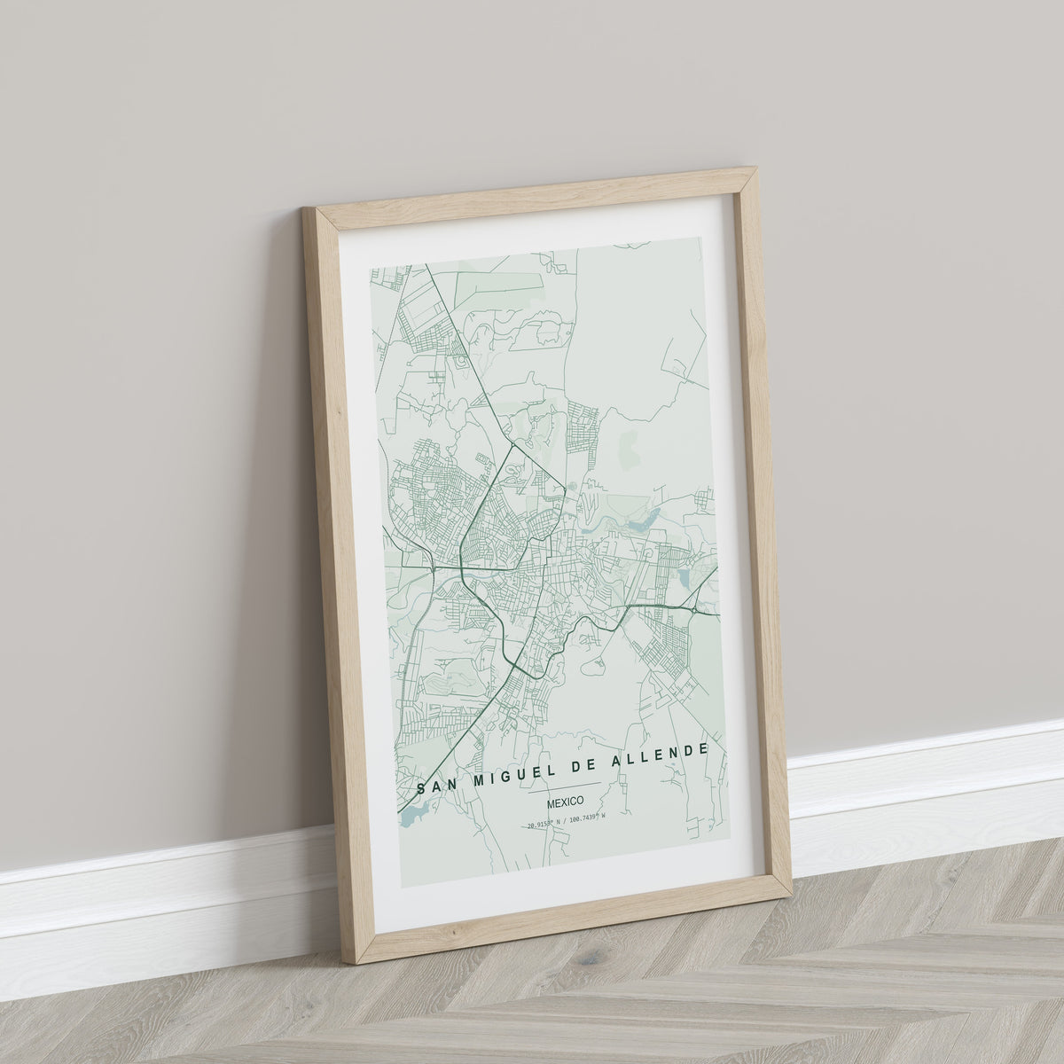 San Miguel de Allende, Mexico map print in the Forest theme in a light wooden frame leaning against a pale wall
