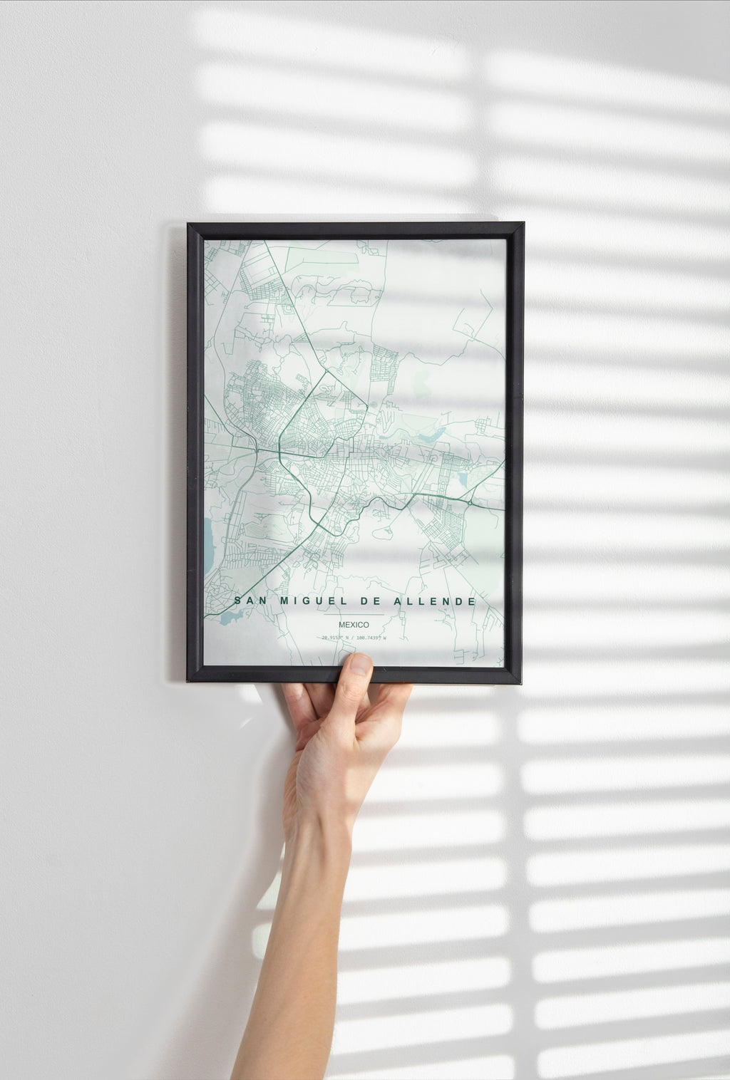 San Miguel de Allende, Mexico map print in the Forest theme in a black frame held against a pale wall