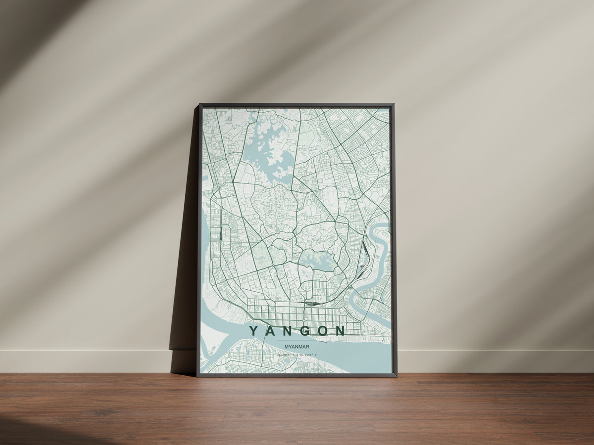 Yangon, Myanmar map print in the Forest theme in a black frame on a wooden surface against a pale wall