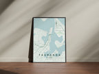 Tauranga, Bay of Plenty, New Zealand map print in the Forest theme in a black frame on a wooden surface against a pale wall