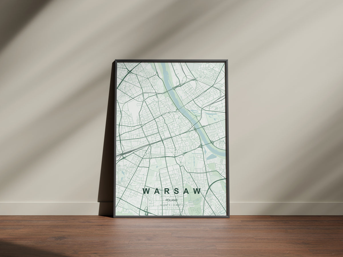 Warsaw map print in the Forest theme in a black frame on a wooden surface against a pale wall