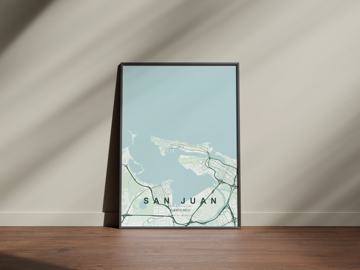 San Juan, Puerto Rico, United States map print in the Forest theme in a black frame on a wooden surface against a pale wall