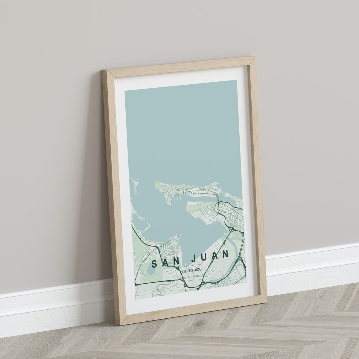 San Juan, Puerto Rico, United States map print in the Forest theme in a light wooden frame leaning against a pale wall