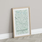 Bucharest map print in the Forest theme in a light wooden frame leaning against a pale wall