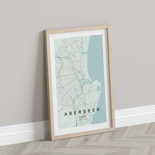 Aberdeen, Scotland, United Kingdom map print in the Forest theme in a light wooden frame leaning against a pale wall