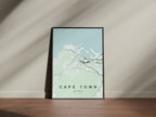 Cape Town, Western Cape, South Africa map print in the Forest theme in a black frame on a wooden surface against a pale wall
