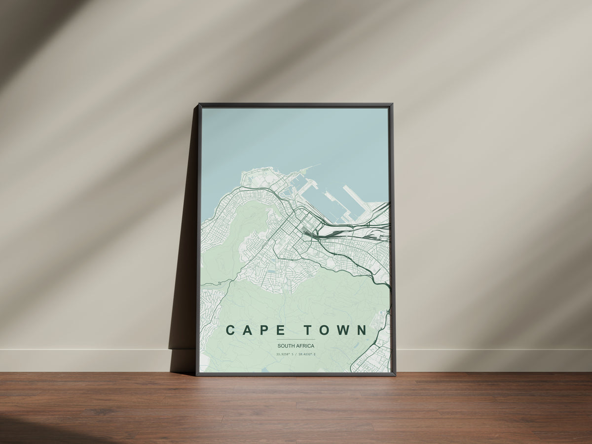 Cape Town, Western Cape, South Africa map print in the Forest theme in a black frame on a wooden surface against a pale wall