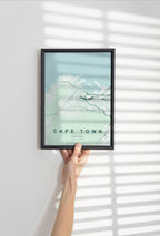 Cape Town, Western Cape, South Africa map print in the Forest theme in a black frame held against a pale wall