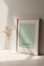 George, Western Cape, South Africa map print in the Forest theme in a light wooden frame on a shelf beside a glass vase