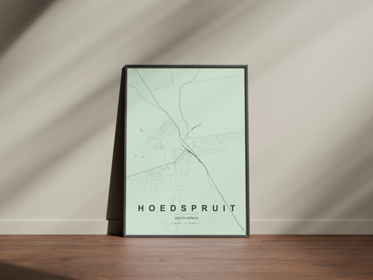 Hoedspruit, Limpopo, South Africa map print in the Forest theme in a black frame on a wooden surface against a pale wall
