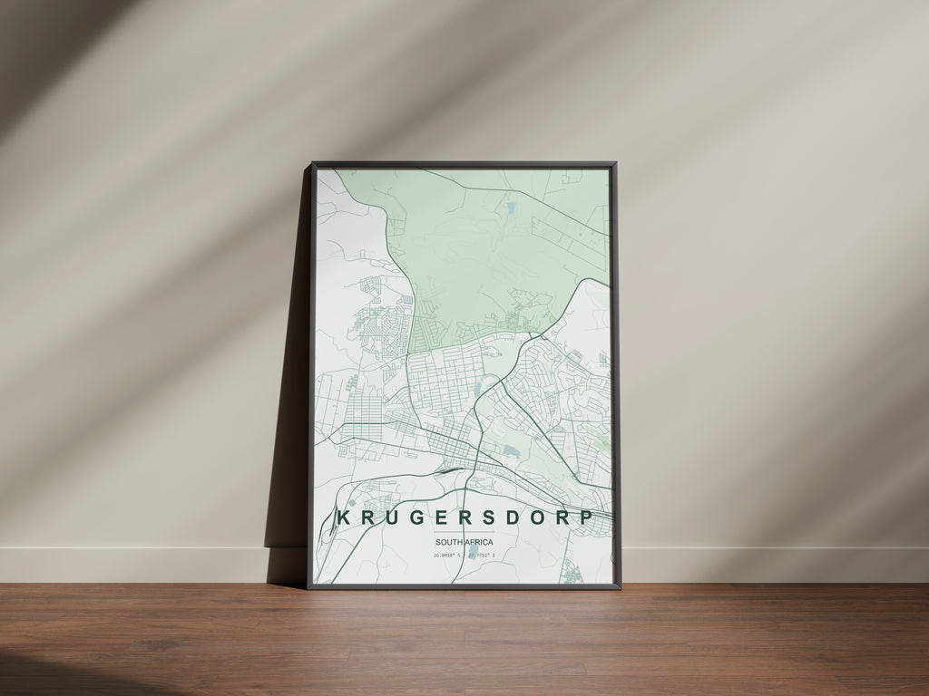 Krugersdorp, Gauteng, South Africa map print in the Forest theme in a black frame on a wooden surface against a pale wall