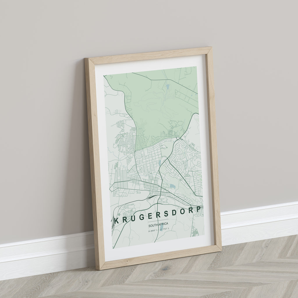 Krugersdorp, Gauteng, South Africa map print in the Forest theme in a light wooden frame leaning against a pale wall