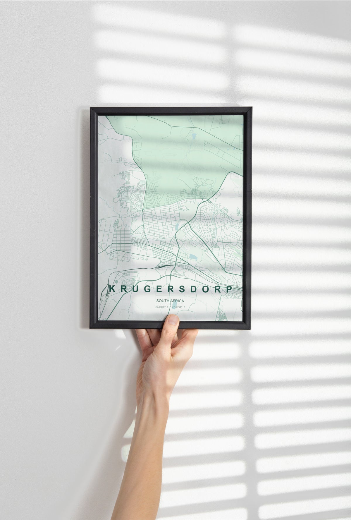 Krugersdorp, Gauteng, South Africa map print in the Forest theme in a black frame held against a pale wall