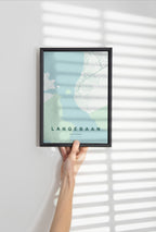 Langebaan, Western Cape, South Africa map print in the Forest theme in a black frame held against a pale wall