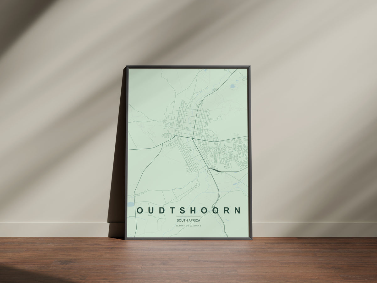 Oudtshoorn, Western Cape, South Africa map print in the Forest theme in a black frame on a wooden surface against a pale wall