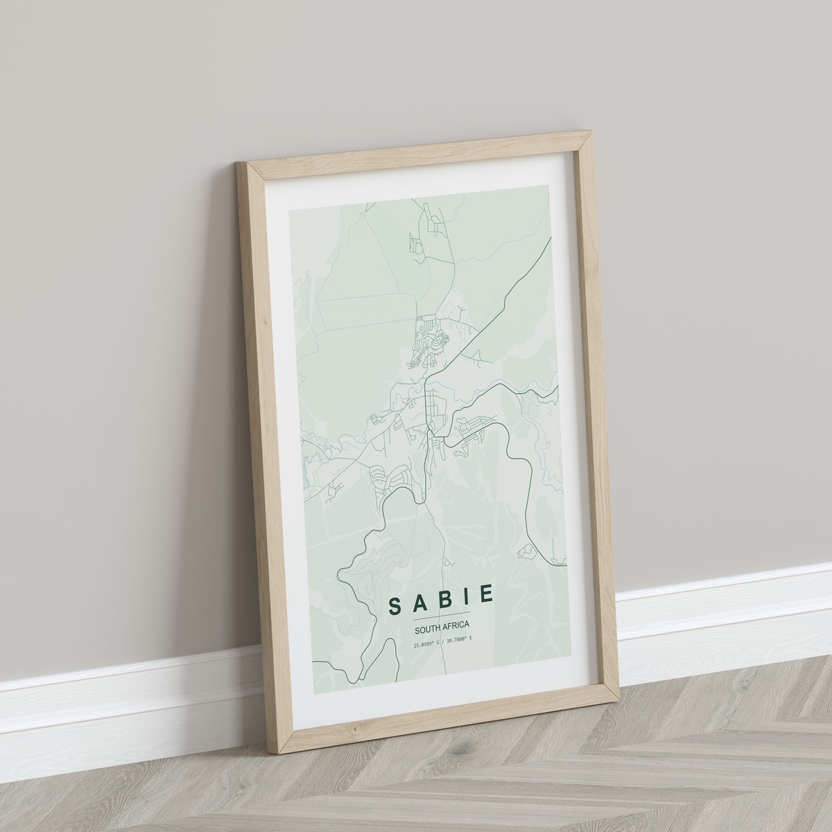 Sabie, Mpumalanga, South Africa map print in the Forest theme in a light wooden frame leaning against a pale wall