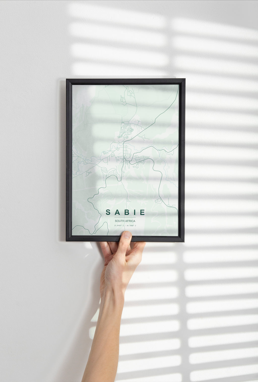 Sabie, Mpumalanga, South Africa map print in the Forest theme in a black frame held against a pale wall