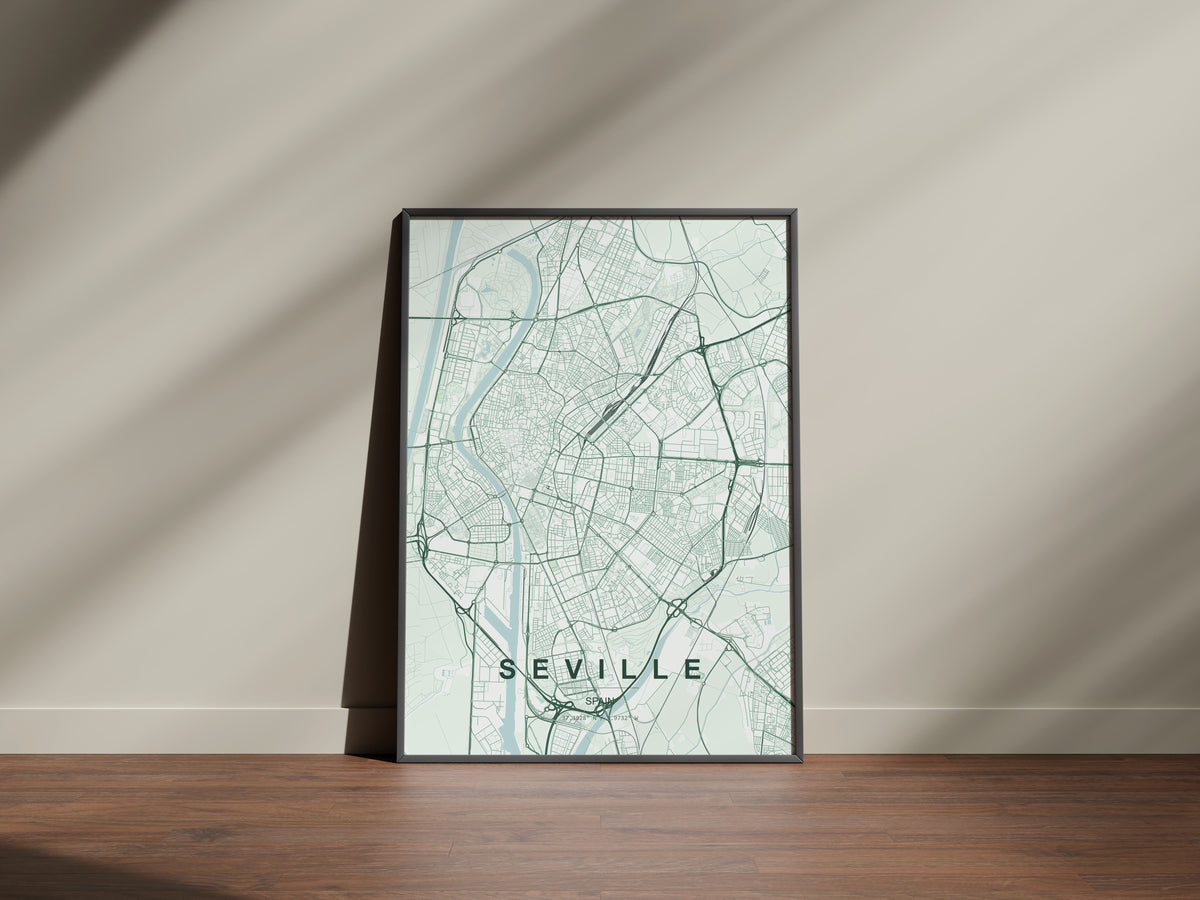 Seville map print in the Forest theme in a black frame on a wooden surface against a pale wall
