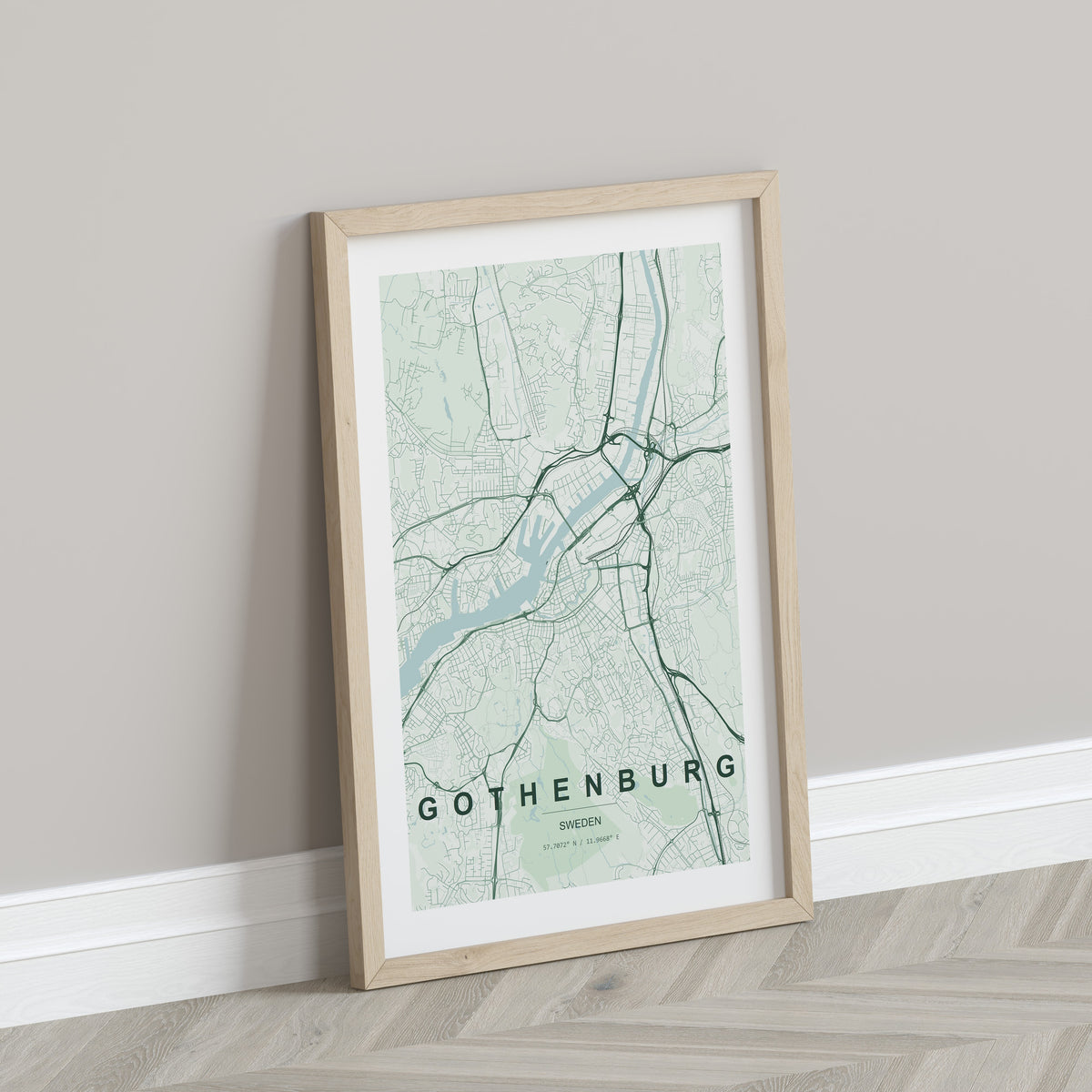 Gothenburg map print in the Forest theme in a light wooden frame leaning against a pale wall