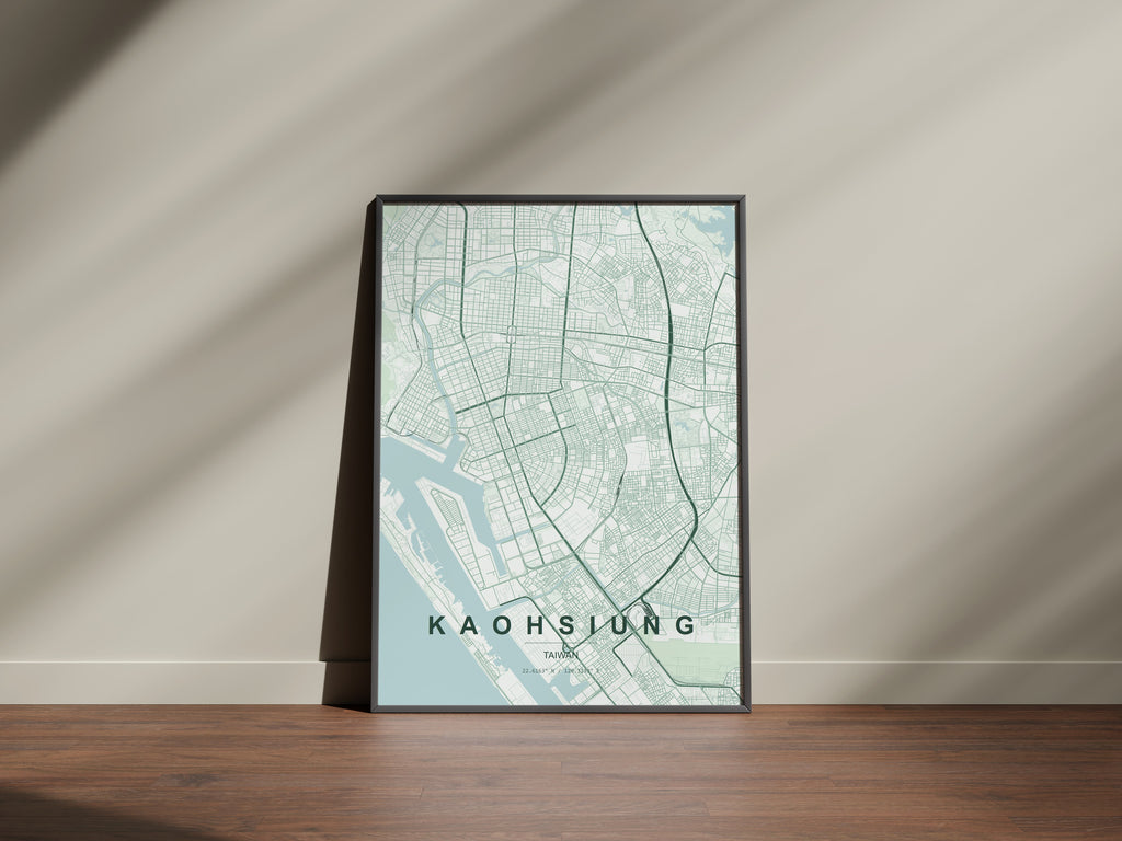 Kaohsiung, Taiwan map print in the Forest theme in a black frame on a wooden surface against a pale wall