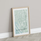 Kaohsiung, Taiwan map print in the Forest theme in a light wooden frame leaning against a pale wall