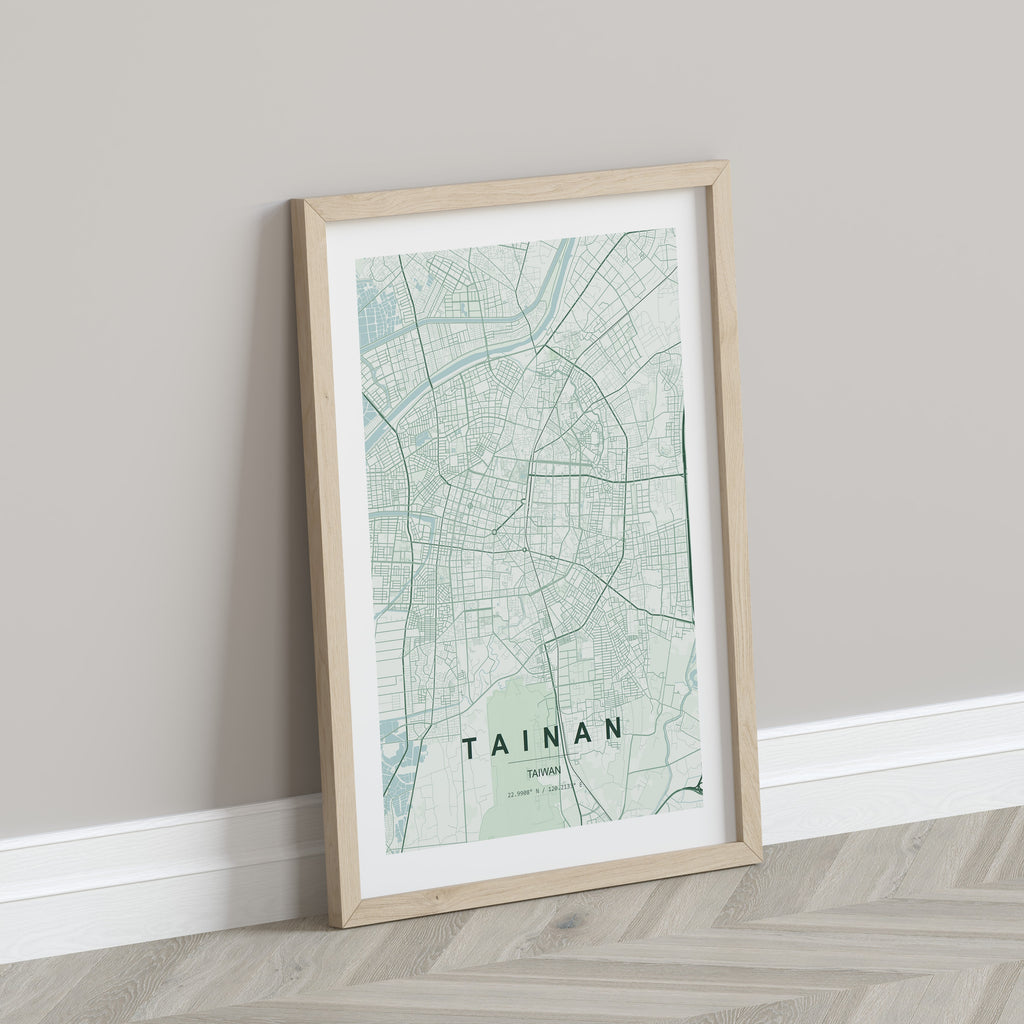 Tainan, Taiwan map print in the Forest theme in a light wooden frame leaning against a pale wall