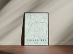 Chiang Mai, Thailand map print in the Forest theme in a black frame on a wooden surface against a pale wall