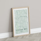 Chiang Mai, Thailand map print in the Forest theme in a light wooden frame leaning against a pale wall