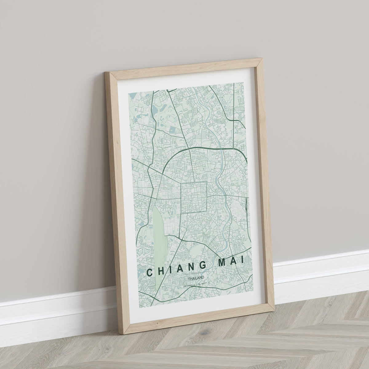 Chiang Mai, Thailand map print in the Forest theme in a light wooden frame leaning against a pale wall